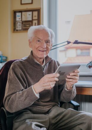 Positive Senior using Digital Tablet